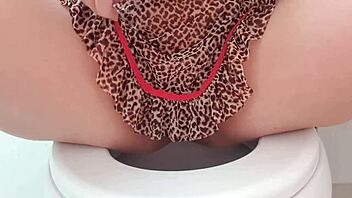 Crossdressing beauty flaunts her big pussy in see-through cami