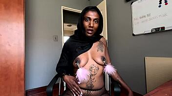 An amateur Indian woman wears a hijab and has pierced nipples while she smokes